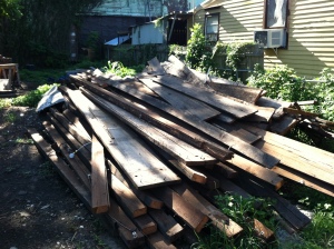 Pile of barge board salvaged from the interior walls that will be utilized in exterior repairs.